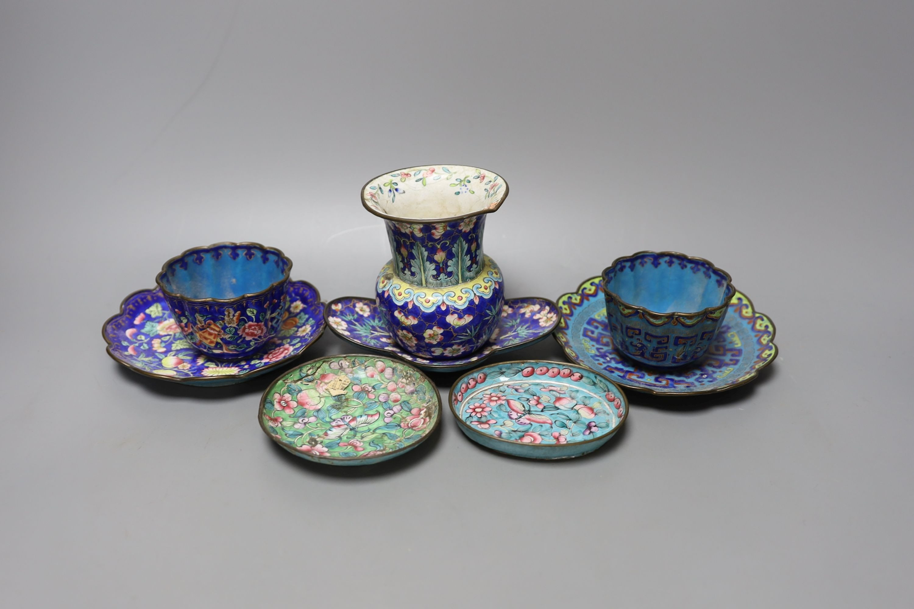 A group of 19th century Canton enamelled wares, including a vase and stand, two tea bowls and saucers and two dishes